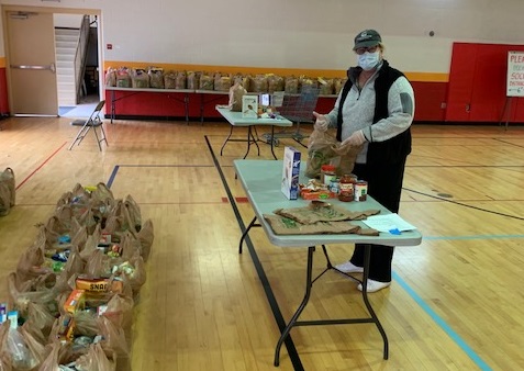 Attorney Sandy Knapp organizes donated food at the YMCA