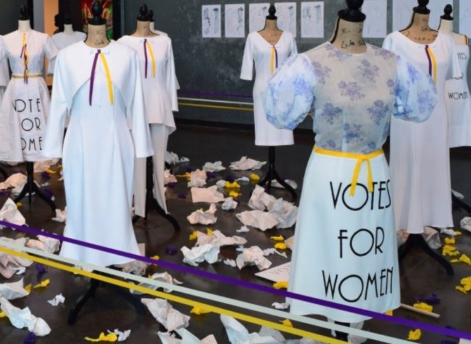 Women's suffrage exhibit at the Delaware Contemporary showing mannequins in dresses with ballots