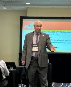 Community association lawyer Elliot Berton speaks in front of a screen at CAI Keystone Community Live 2026